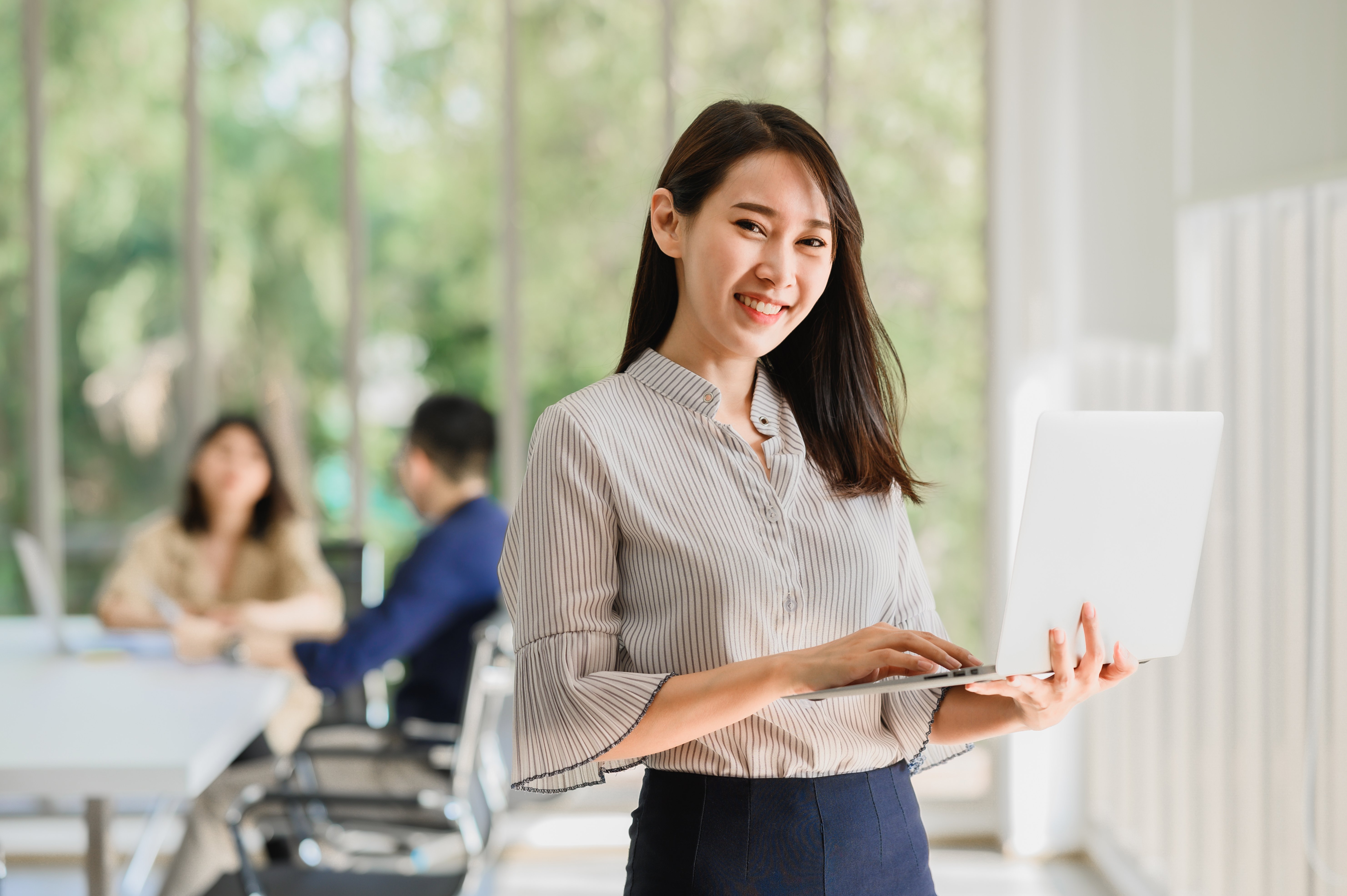 vecteezy_asian-woman-holding-a-laptop_1312926