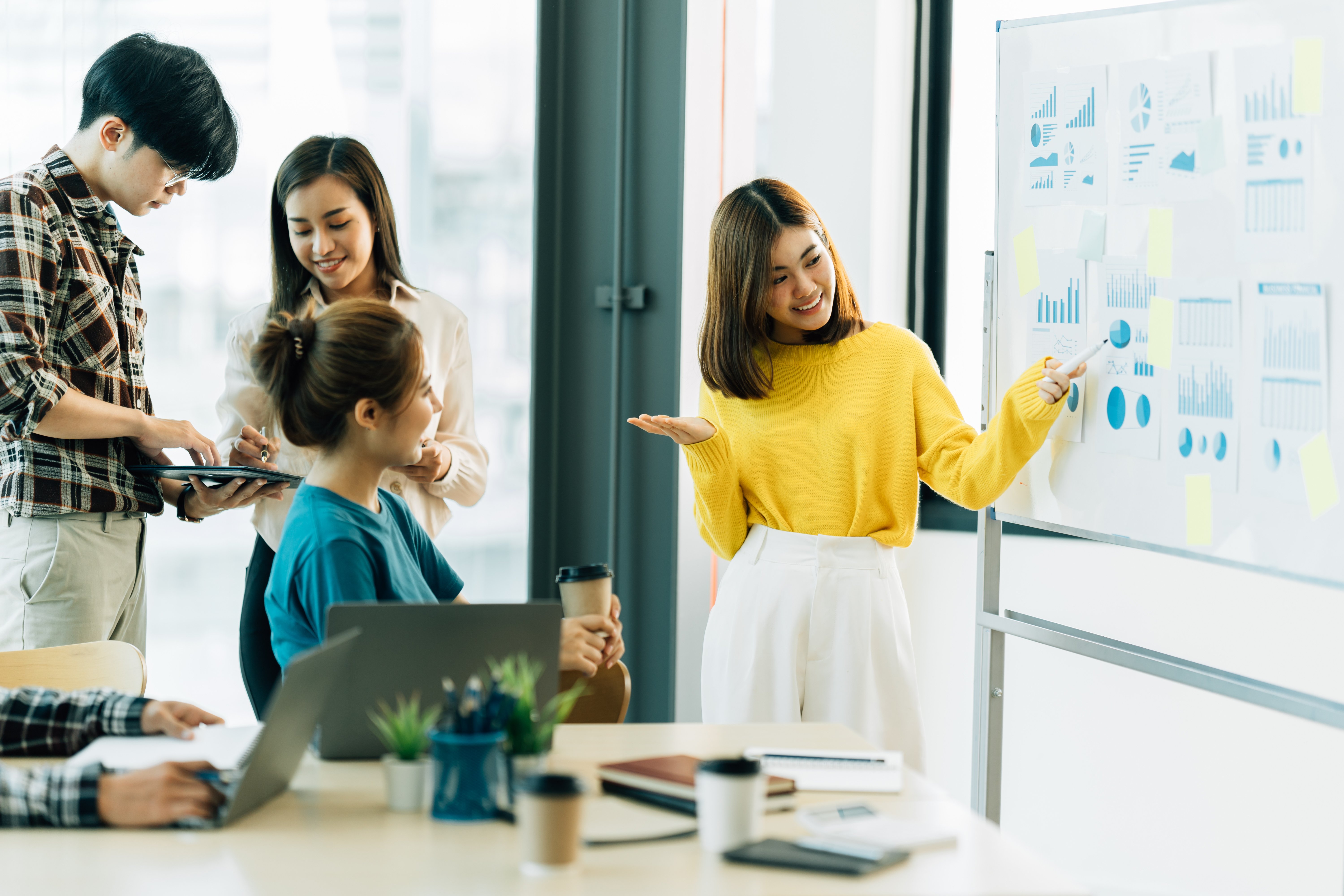 vecteezy_group-of-four-happy-young-asian-corporate-people-teammates_7389456