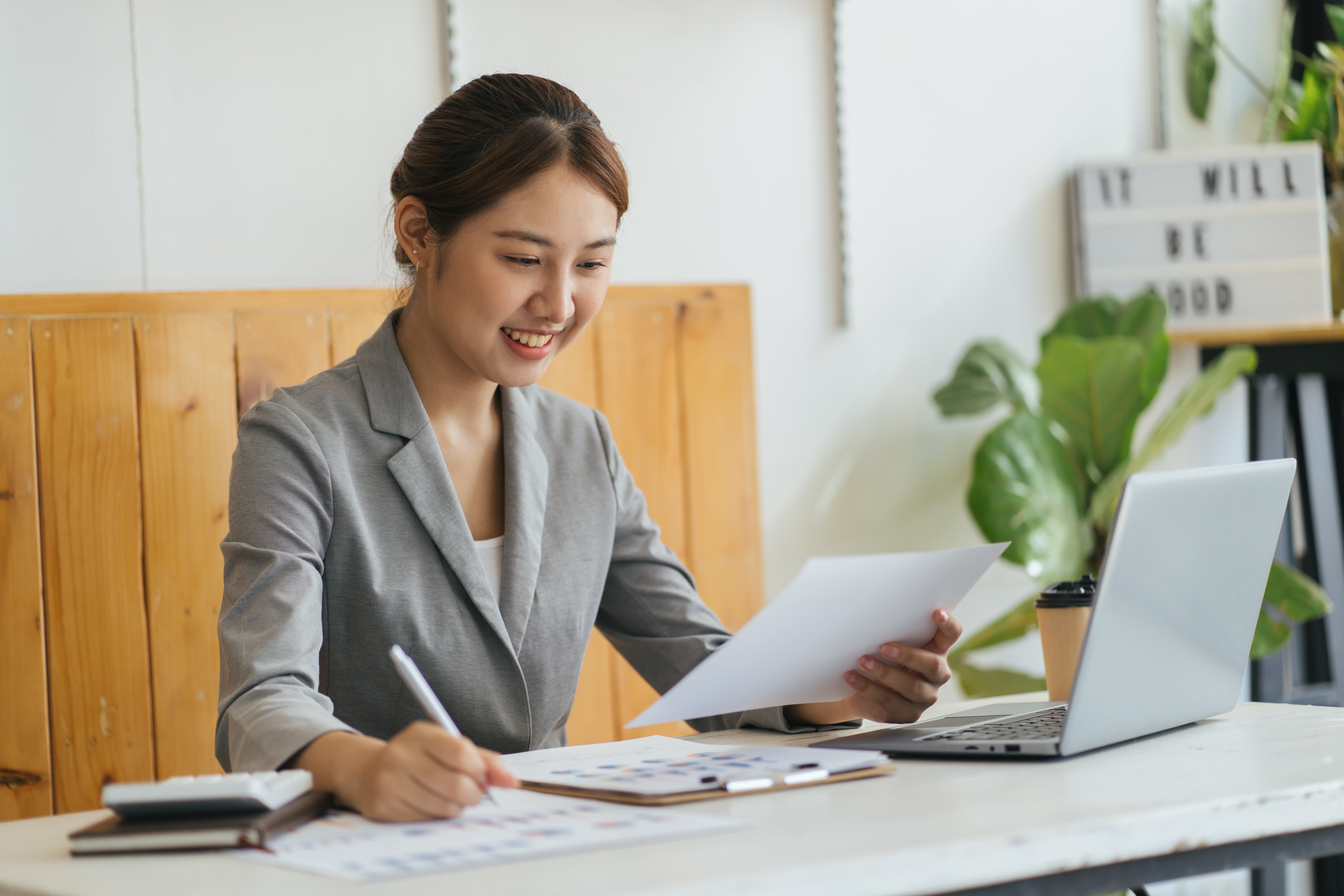 vecteezy_happy-young-asian-woman-sitting-and-using-laptop-in-living_7359604