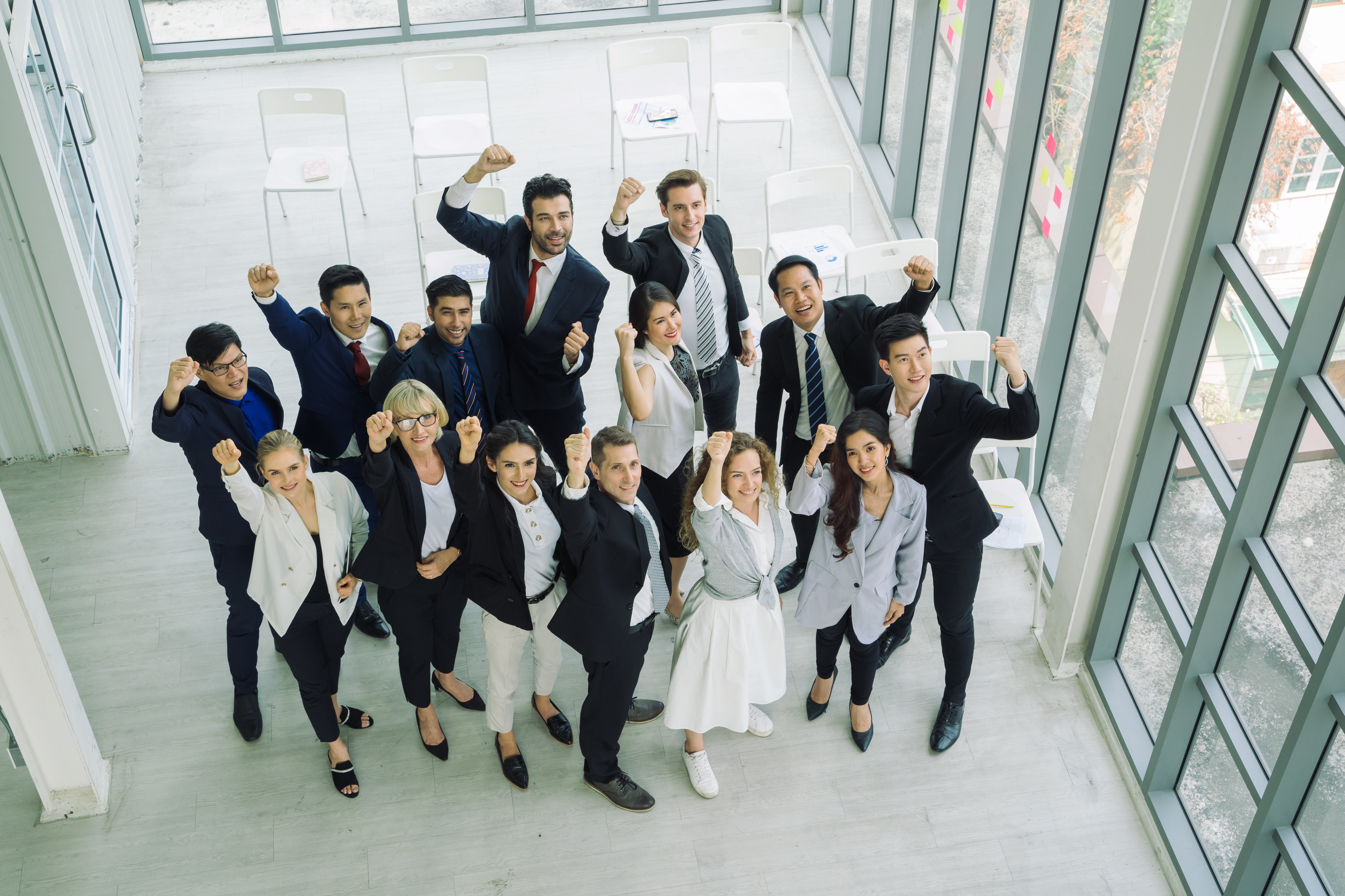 vecteezy_multiethnic-group-of-business-professionals-with-fists-up_1226790