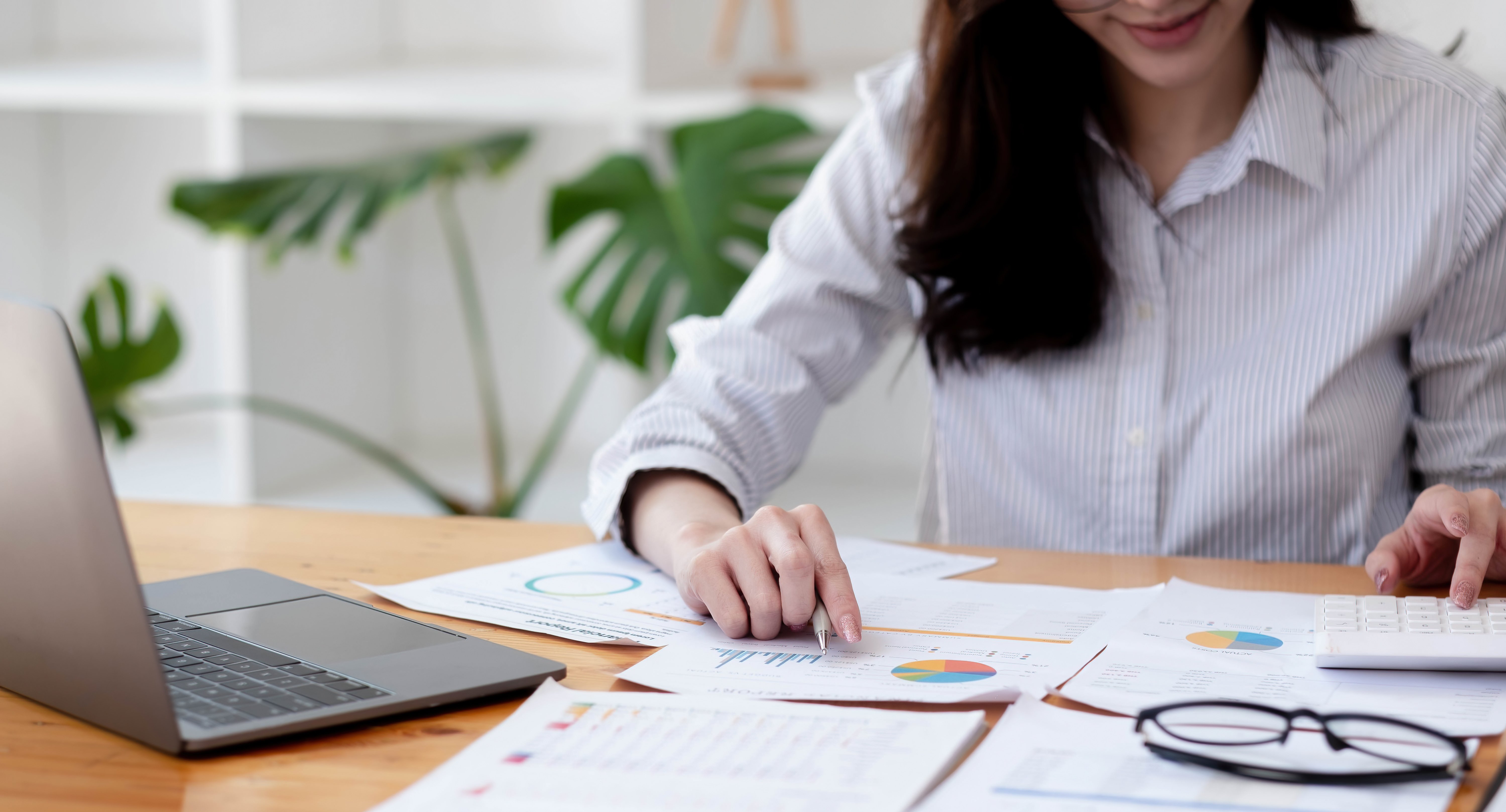 vecteezy_portrait-asian-woman-with-financial-report-and-calculator_4519247